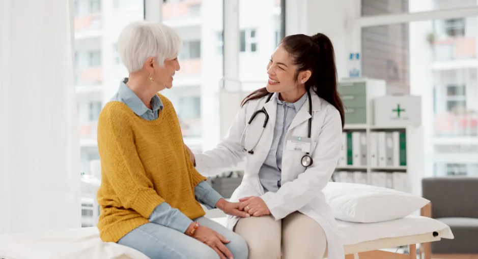 Doctor speaking with an older patient in a medical exam room